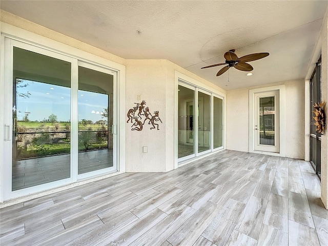 wooden deck featuring a ceiling fan