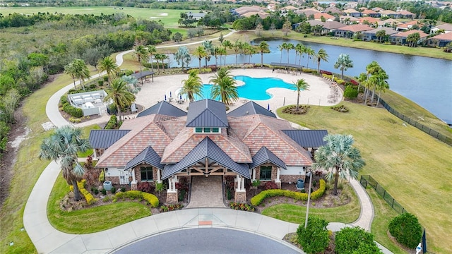 birds eye view of property with a water view