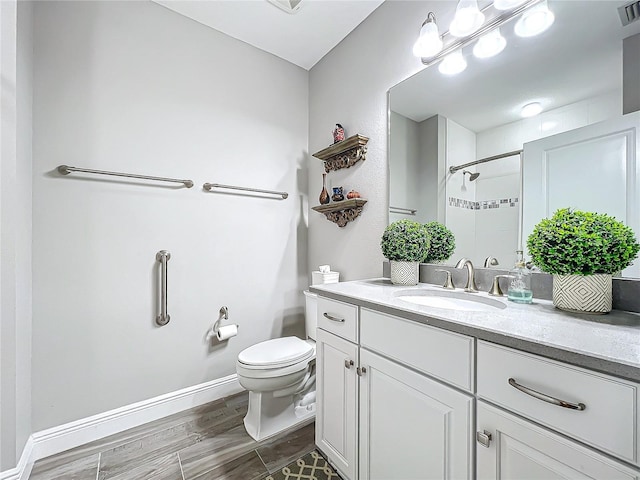 full bath featuring toilet, visible vents, vanity, baseboards, and a shower