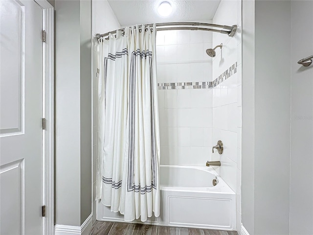 full bathroom with shower / bath combo with shower curtain and wood finished floors