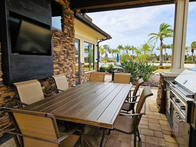 view of patio with exterior kitchen and outdoor dining space