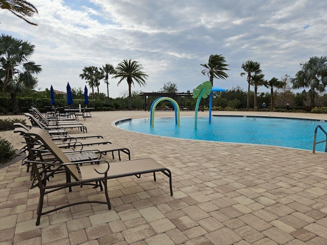 community pool with a patio area