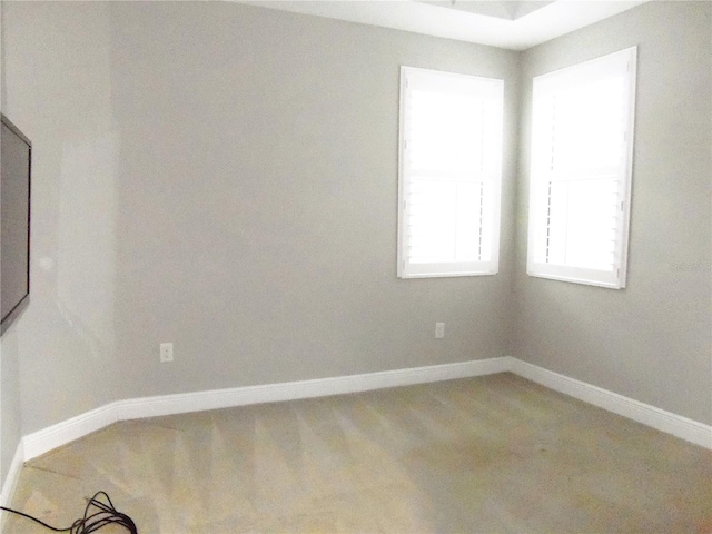 spare room with baseboards