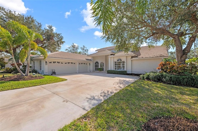 view of front of home with a garage and a front yard