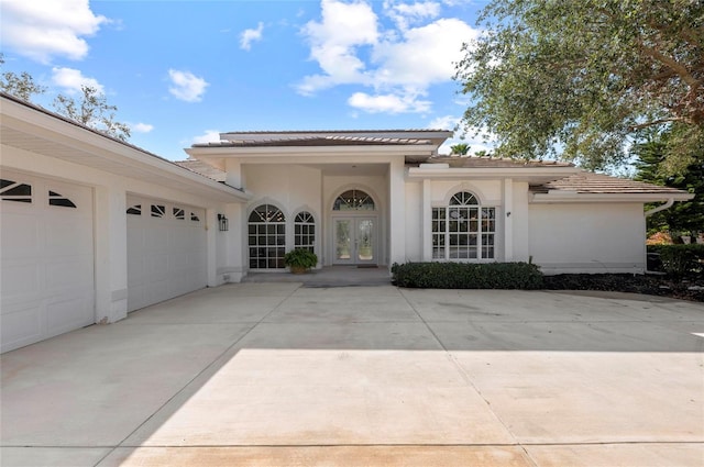 property entrance with french doors and a garage