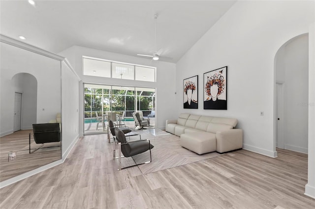 living room with high vaulted ceiling, light hardwood / wood-style floors, and ceiling fan