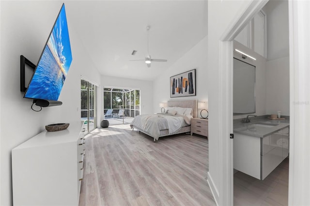 bedroom with high vaulted ceiling, sink, access to exterior, ceiling fan, and light wood-type flooring