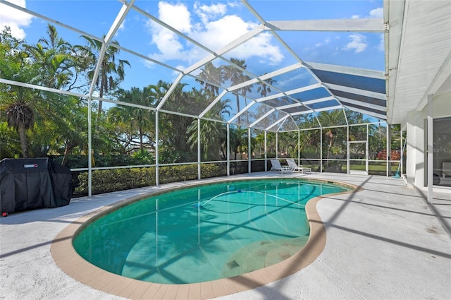 view of swimming pool featuring a grill, a lanai, and a patio