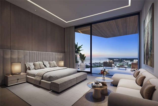 bedroom with access to exterior, a water view, and floor to ceiling windows