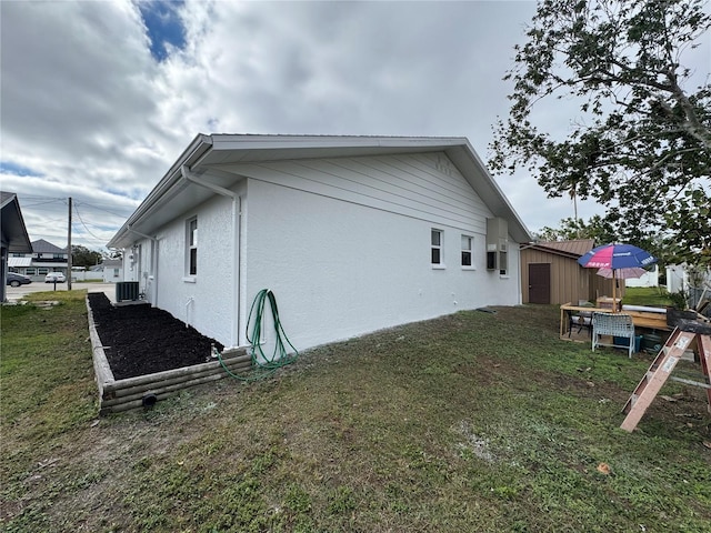 view of property exterior with a yard and cooling unit