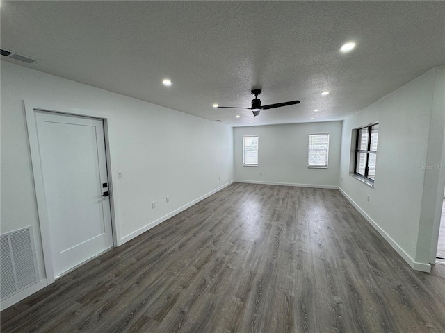 unfurnished room with ceiling fan, dark hardwood / wood-style floors, and a textured ceiling