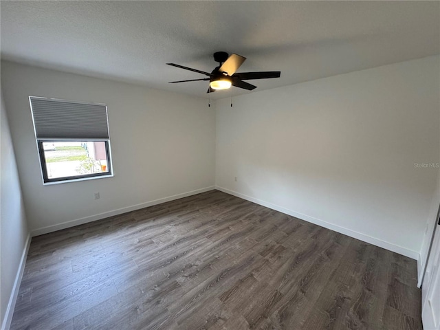 unfurnished room featuring a textured ceiling, ceiling fan, and dark wood-type flooring