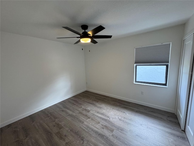 unfurnished room with ceiling fan and hardwood / wood-style floors