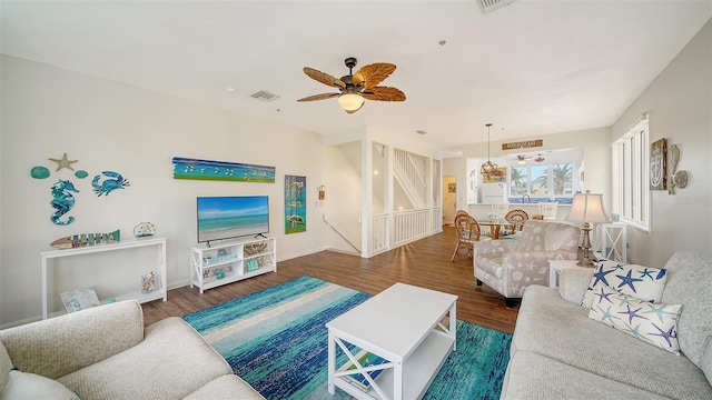 living area featuring wood finished floors, visible vents, and a ceiling fan