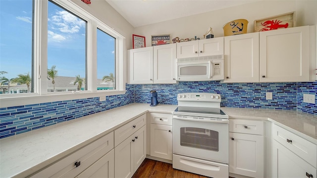 kitchen with white appliances, dark wood finished floors, white cabinets, and decorative backsplash