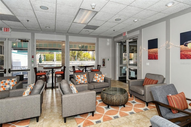 interior space with a drop ceiling and tile patterned floors