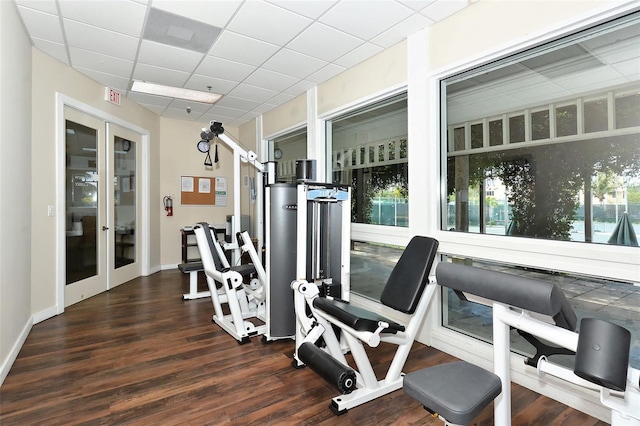 exercise room with french doors, a drop ceiling, wood finished floors, and visible vents