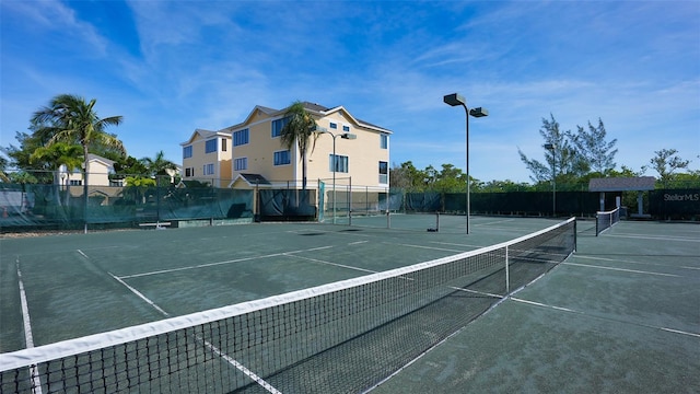 view of tennis court featuring fence