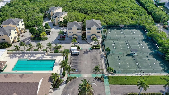 drone / aerial view featuring a view of trees and a residential view