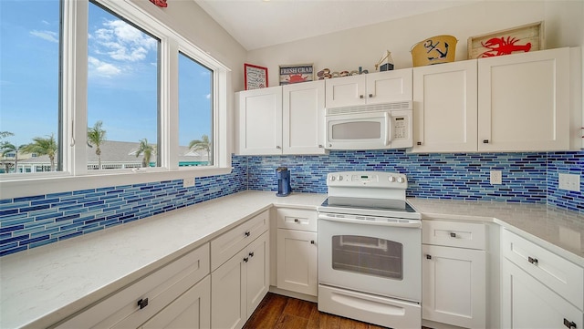 kitchen featuring decorative backsplash, white cabinets, and white appliances