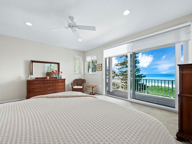 carpeted bedroom with ceiling fan, access to exterior, and a water view