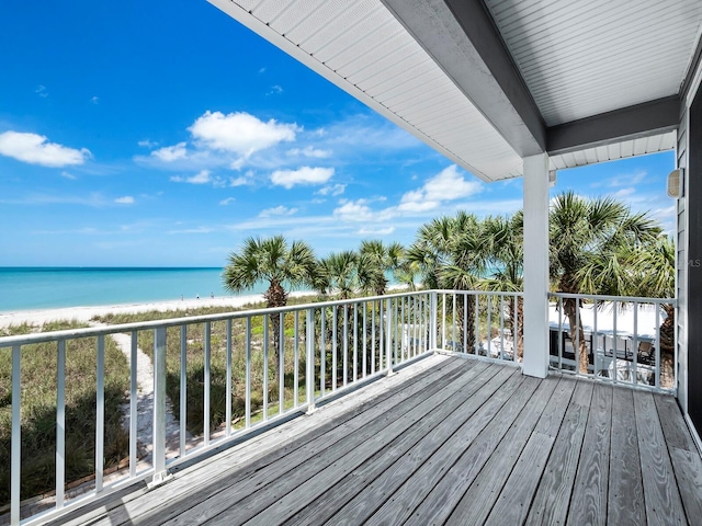 wooden terrace with a water view and a beach view