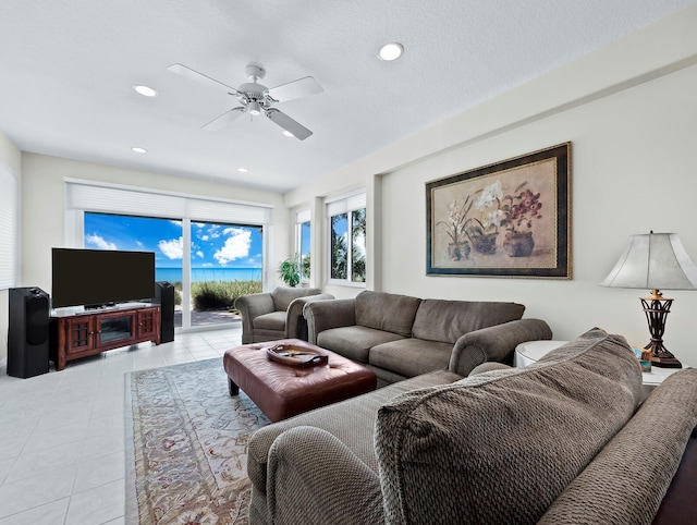 living room featuring ceiling fan and light tile patterned flooring