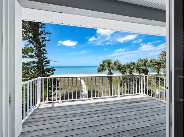 deck featuring a view of the beach and a water view