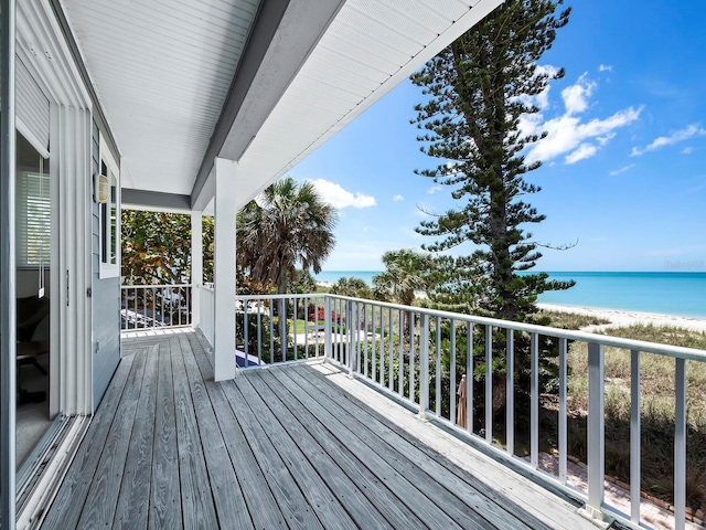 wooden terrace with a beach view and a water view