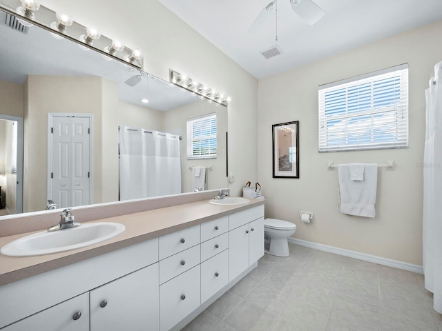 bathroom with ceiling fan, vanity, a shower with shower curtain, and toilet