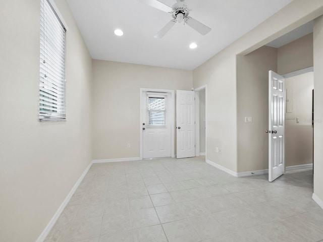 spare room featuring ceiling fan and light tile patterned flooring