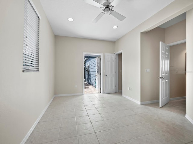 tiled empty room with ceiling fan