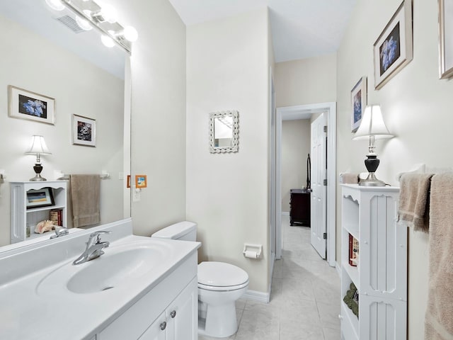 bathroom featuring tile patterned flooring, vanity, and toilet