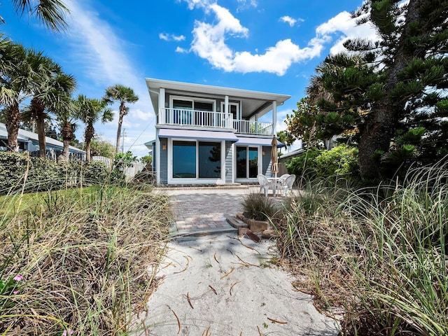 beach home with a balcony and a patio