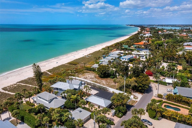 drone / aerial view featuring a water view and a beach view