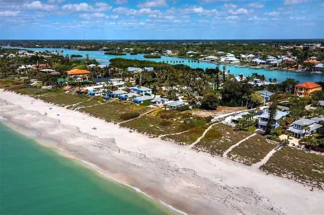 bird's eye view featuring a water view and a beach view