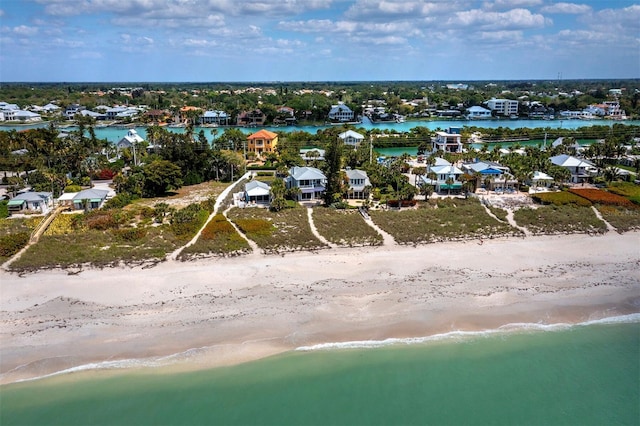 birds eye view of property featuring a water view and a view of the beach