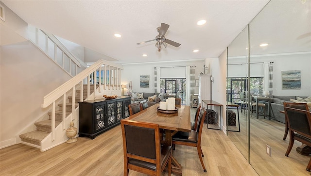 dining space with ceiling fan, light hardwood / wood-style flooring, and a textured ceiling