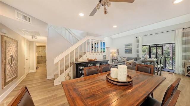 dining area featuring light wood-type flooring, vaulted ceiling, and ceiling fan