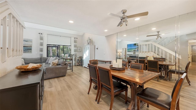 dining space with ceiling fan and light wood-type flooring