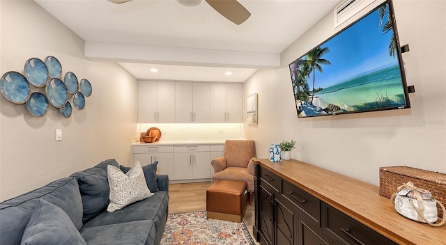 living room featuring light hardwood / wood-style floors and ceiling fan