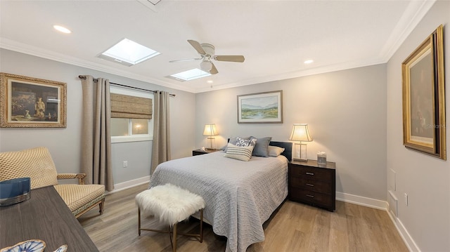 bedroom featuring ceiling fan, light hardwood / wood-style floors, and ornamental molding