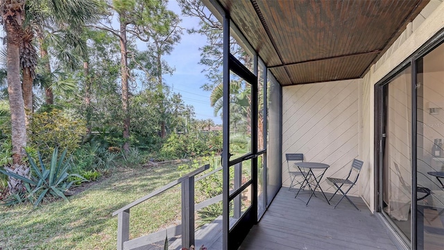 unfurnished sunroom featuring wood ceiling