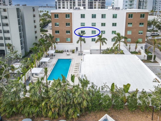 view of pool with a water view and a patio area