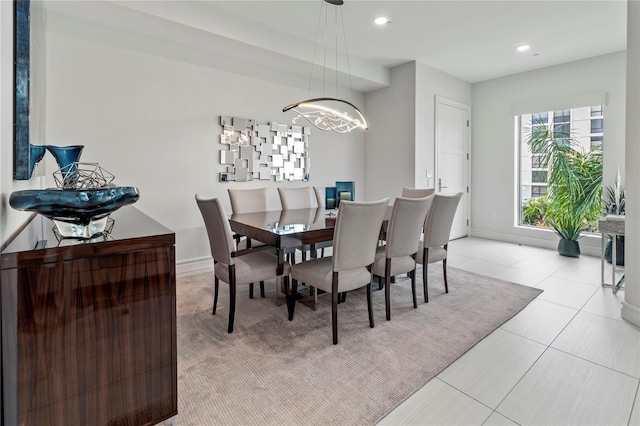 dining space with an inviting chandelier and light tile patterned floors