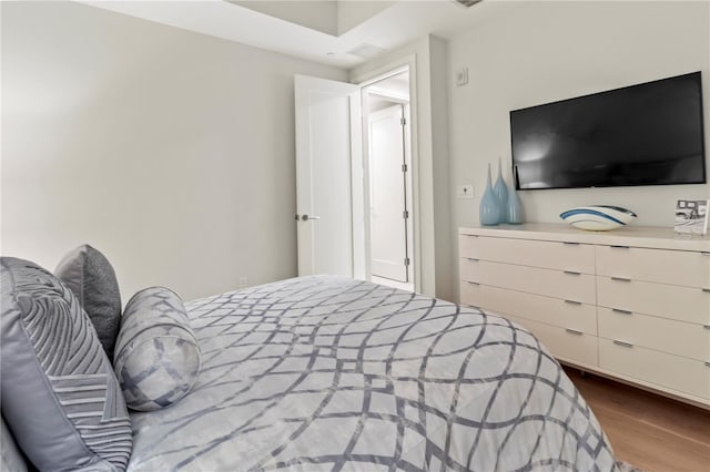 bedroom with hardwood / wood-style flooring