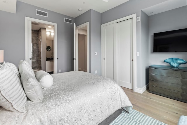 bedroom with light hardwood / wood-style floors and a closet