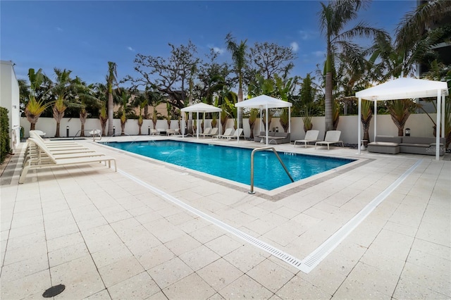 view of swimming pool featuring a gazebo, pool water feature, and a patio