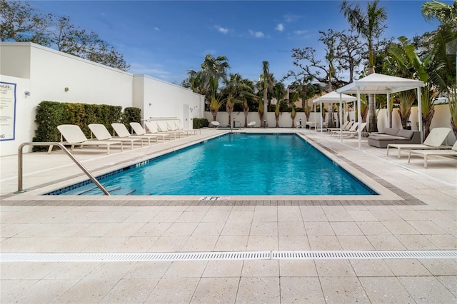 view of swimming pool with a patio and a gazebo