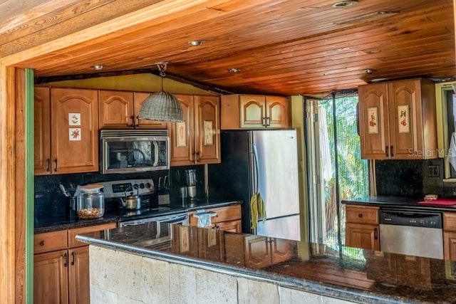 kitchen featuring hanging light fixtures, stainless steel appliances, tasteful backsplash, dark stone countertops, and wood ceiling